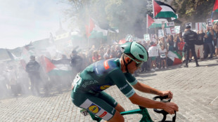 Cyclists swerve protest group in road during Vuelta stage 20